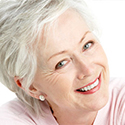 Gray haired woman shows off her smile