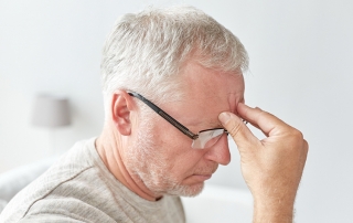 senior man suffering from headache at home