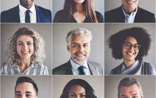 A group of business men and women smiling faces each in their own phase of dental treatment.