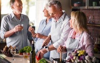 4 Mature friends having fun while making dinner. Here 4 Things to Watch for in Dentistry - Plus One Bonus