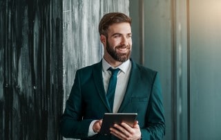 Attractive business man takes a break from working on his iPad