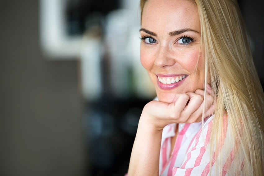 Beautful young blonde woman showing off her smile with Invisalign