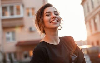 beautiful young woman walks down a busy street